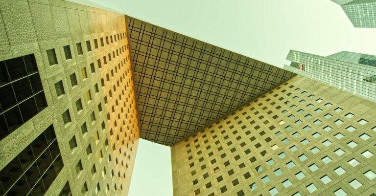 A striking perspective of modern skyscrapers with geometric patterns in a cityscape.