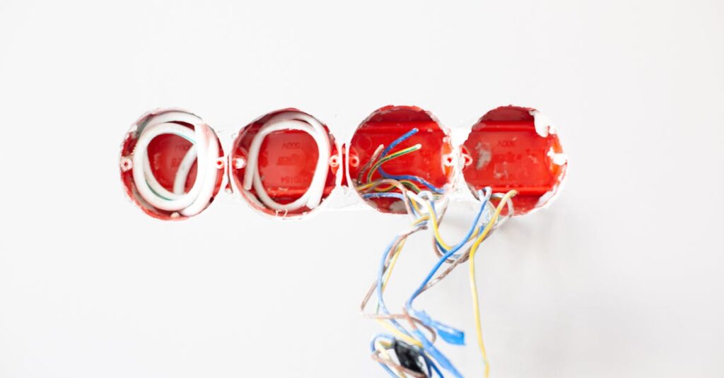 Close-up of exposed electrical wiring in wall sockets ready for installation. Ideal for home improvement contexts.