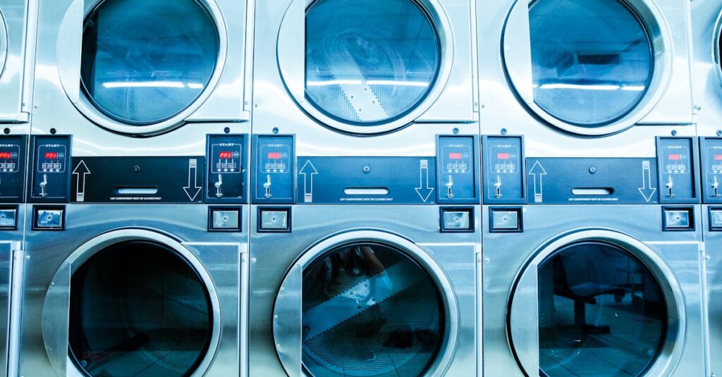 A row of modern washing machines in a launderette, showcasing contemporary laundry technology.